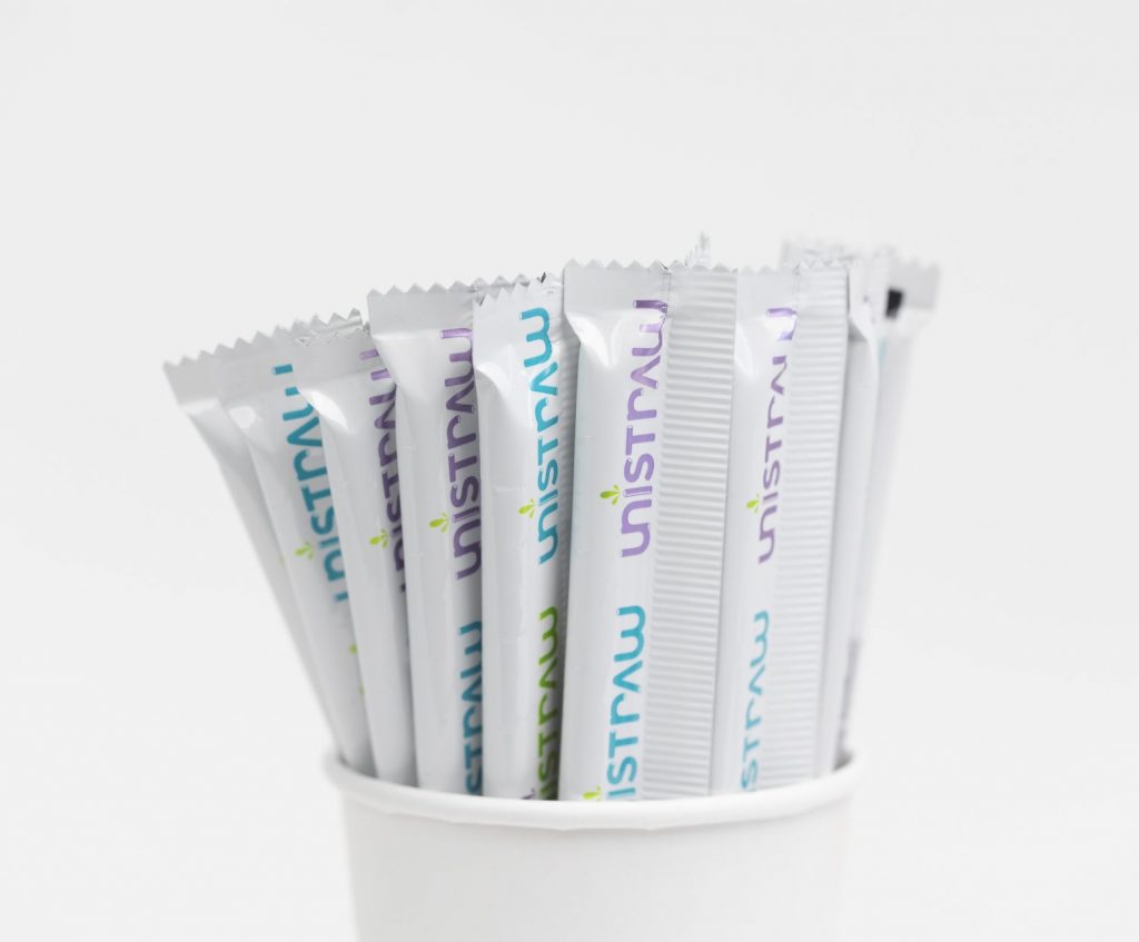 Several Unistraw straws in a cup.