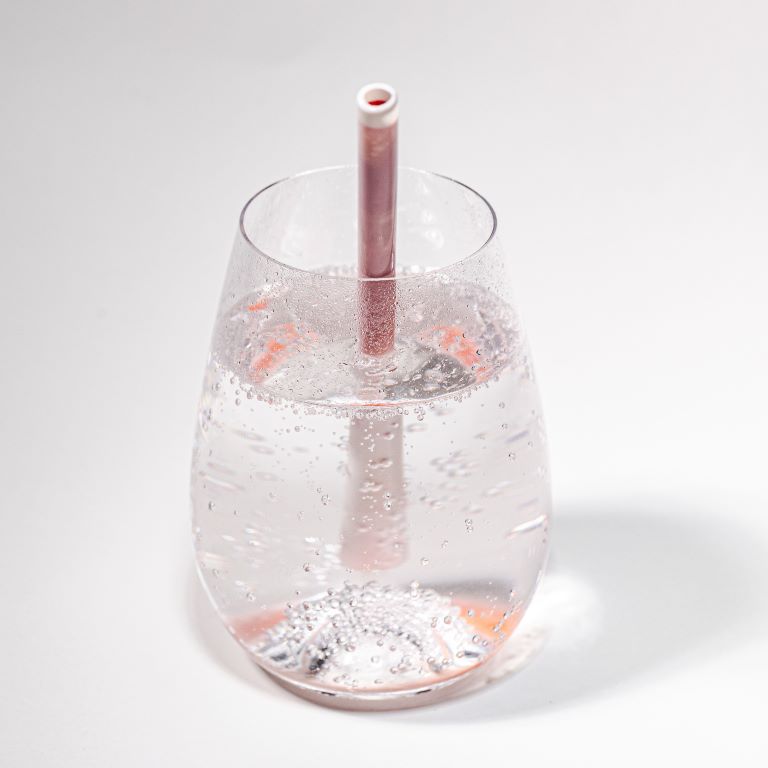 Unistraw in a glass filled with sparkling water